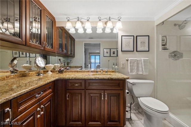 bathroom featuring vanity, ornamental molding, a shower with door, and toilet