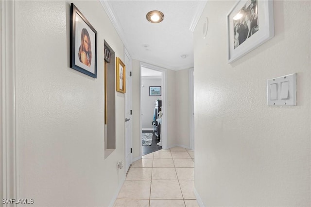 hallway featuring ornamental molding and light tile patterned floors