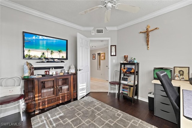 office space featuring wood-type flooring, crown molding, ceiling fan, and a textured ceiling