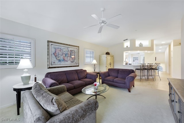 living room with light carpet, ceiling fan, and lofted ceiling