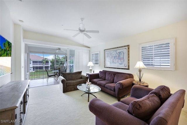 living room featuring a ceiling fan, light colored carpet, and vaulted ceiling