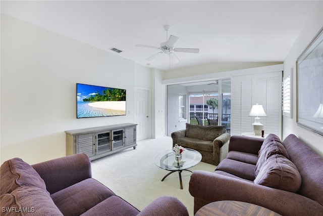 living area with a ceiling fan, plenty of natural light, visible vents, and light colored carpet