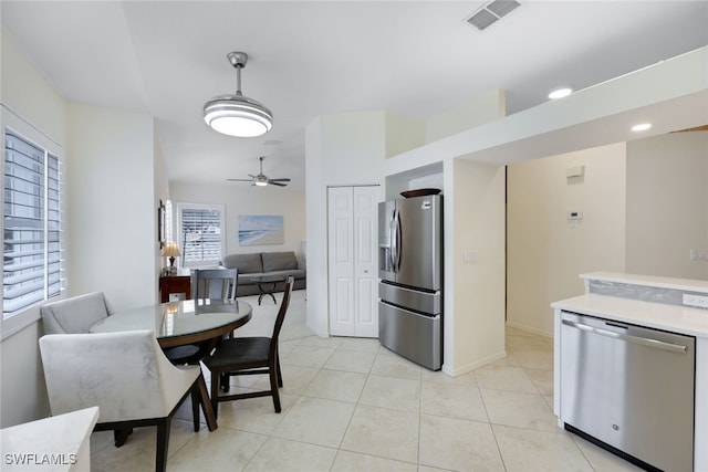 kitchen with open floor plan, stainless steel appliances, light countertops, and visible vents