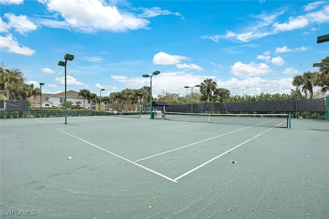 view of tennis court featuring fence