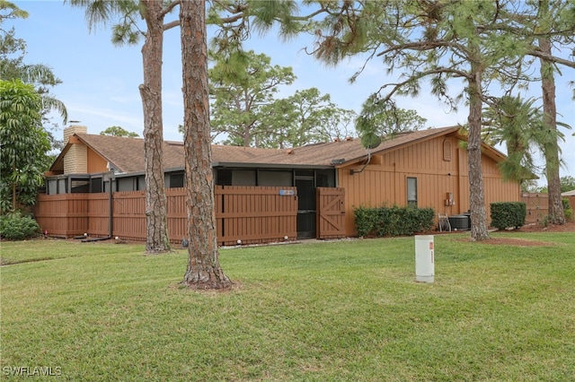 exterior space featuring central AC unit and a yard