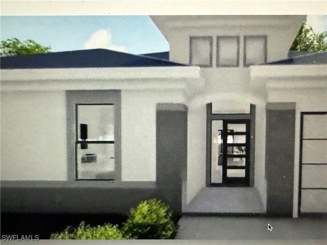 543 Mcarthur Blvd, Lehigh Acres, FL 33974 - property entrance with stucco siding