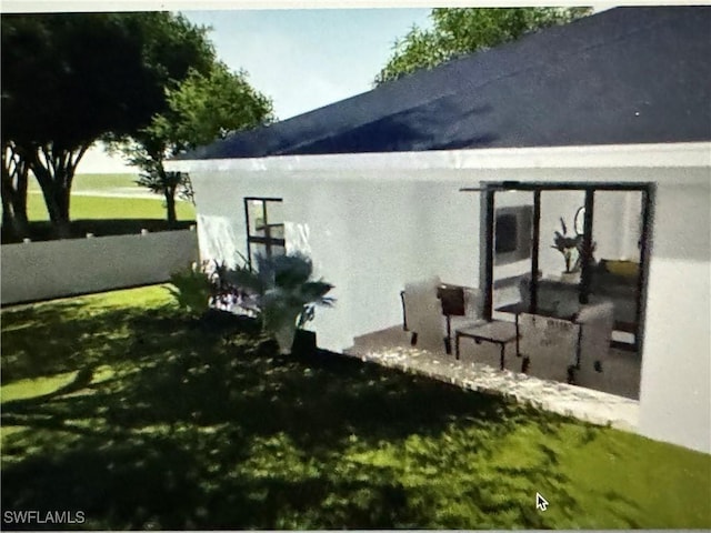 view of property exterior featuring a yard and stucco siding