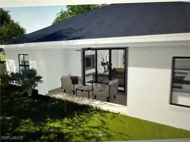 543 Mcarthur Blvd, Lehigh Acres, FL 33974 - rear view of house with stucco siding