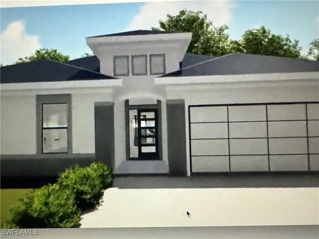 543 Mcarthur Blvd, Lehigh Acres, FL 33974 - view of front facade featuring a garage and stucco siding