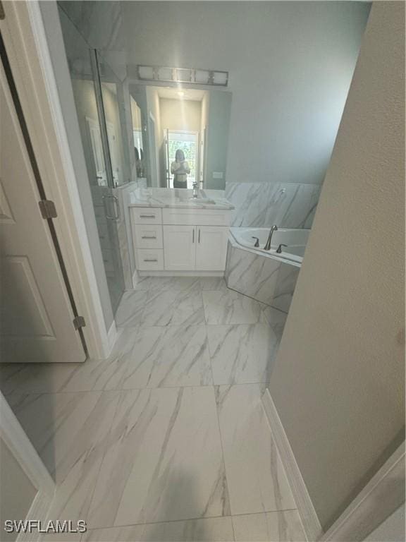 full bathroom with a bath, marble finish floor, a stall shower, and vanity