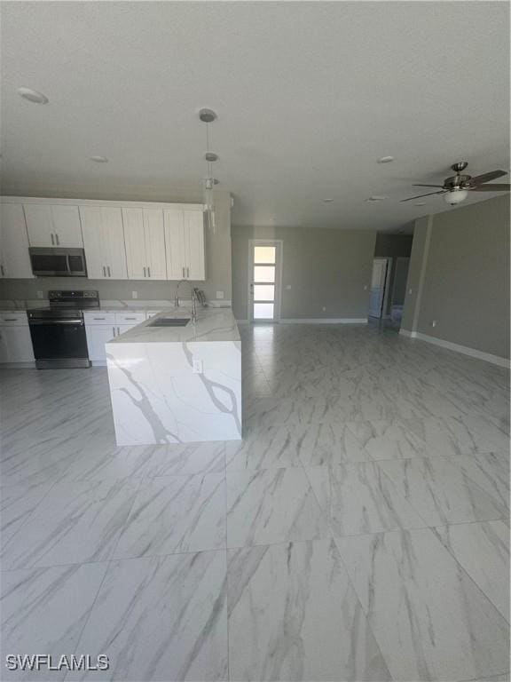 543 Mcarthur Blvd, Lehigh Acres, FL 33974 - kitchen featuring appliances with stainless steel finishes, a sink, white cabinetry, baseboards, and decorative light fixtures