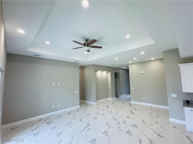 543 Mcarthur Blvd, Lehigh Acres, FL 33974 - unfurnished room with a tray ceiling, ceiling fan, baseboards, recessed lighting, and light marble finish flooring