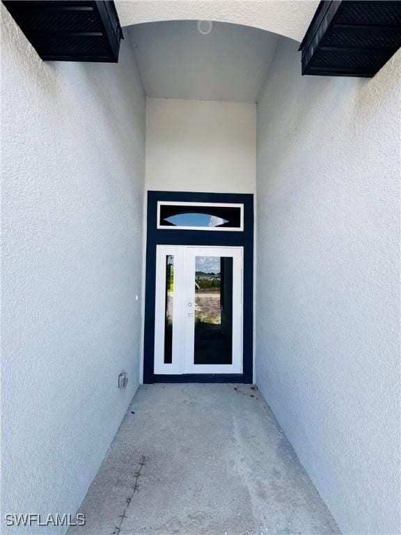543 Mcarthur Blvd, Lehigh Acres, FL 33974 - view of exterior entry featuring stucco siding and french doors