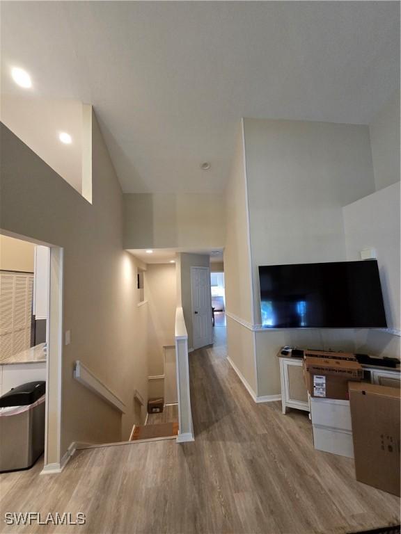 unfurnished living room featuring wood finished floors and baseboards
