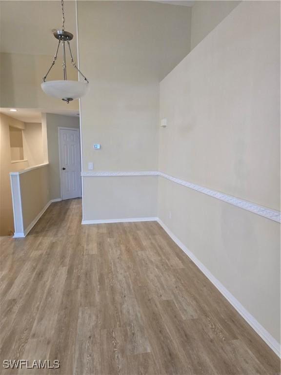 12051 Champions Green Way Unit 322, Fort Myers, FL 33913 - unfurnished dining area with wood finished floors and baseboards
