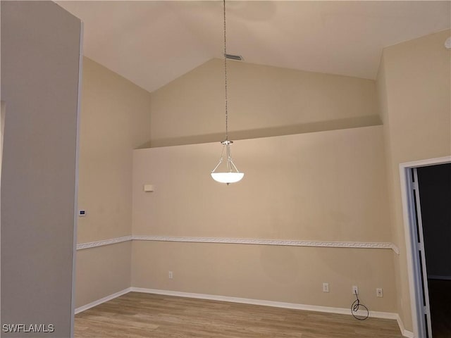 12051 Champions Green Way Unit 322, Fort Myers, FL 33913 - unfurnished dining area featuring wood finished floors, vaulted ceiling, and baseboards