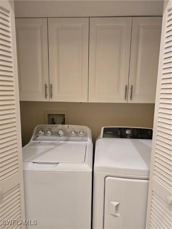 12051 Champions Green Way Unit 322, Fort Myers, FL 33913 - laundry room with washing machine and clothes dryer and cabinet space