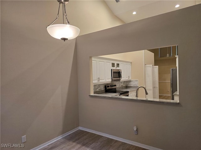 12051 Champions Green Way Unit 322, Fort Myers, FL 33913 - unfurnished dining area featuring dark wood-style flooring, a sink, baseboards, and recessed lighting