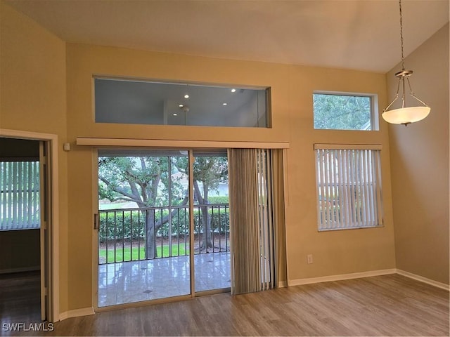 12051 Champions Green Way Unit 322, Fort Myers, FL 33913 - doorway featuring wood finished floors, a towering ceiling, and baseboards