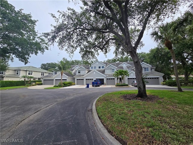 12051 Champions Green Way Unit 322, Fort Myers, FL 33913 - view of property with a residential view, asphalt driveway, and an attached garage