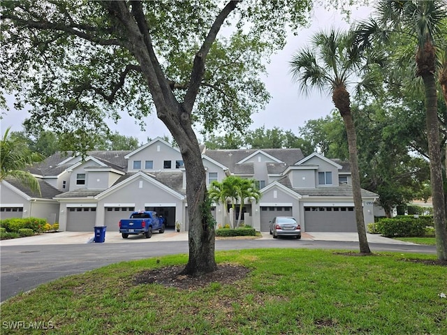 12051 Champions Green Way Unit 322, Fort Myers, FL 33913 - view of front of home featuring asphalt driveway, a garage, a residential view, and a front yard