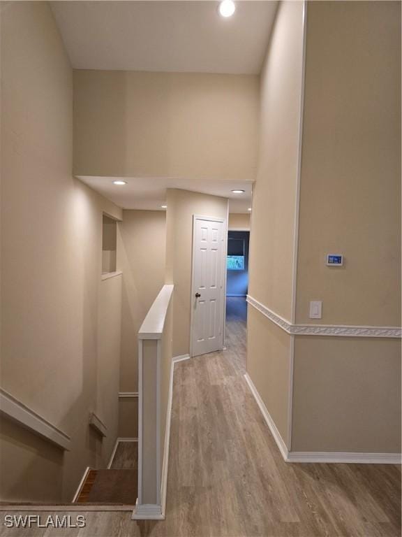 12051 Champions Green Way Unit 322, Fort Myers, FL 33913 - hallway with wood finished floors, recessed lighting, an upstairs landing, and baseboards