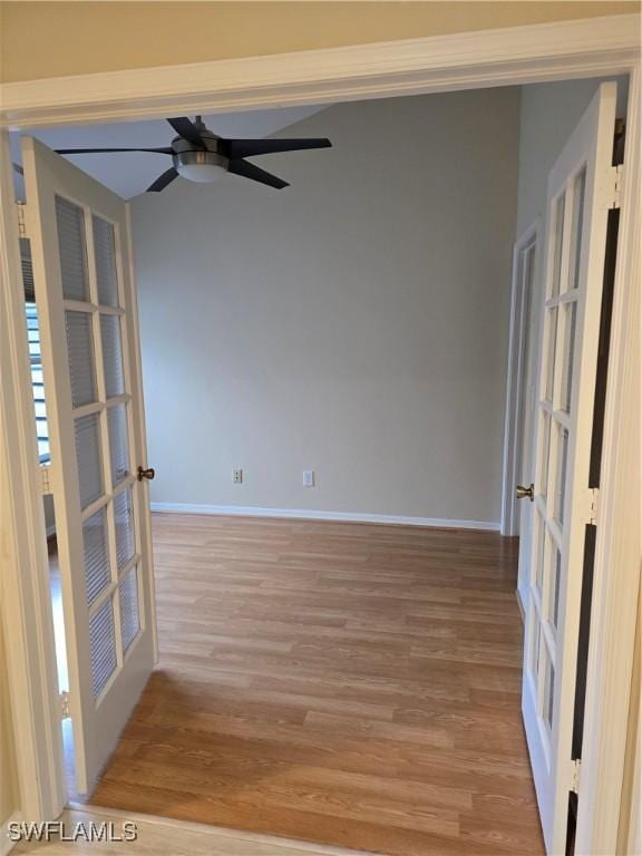 12051 Champions Green Way Unit 322, Fort Myers, FL 33913 - empty room with french doors, light wood-style floors, baseboards, and a ceiling fan