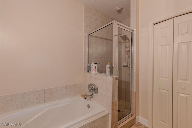 bathroom with shower with separate bathtub