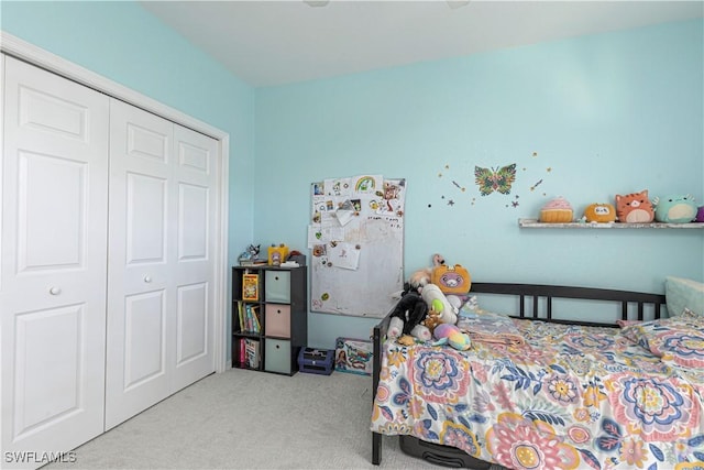 bedroom with light carpet and a closet