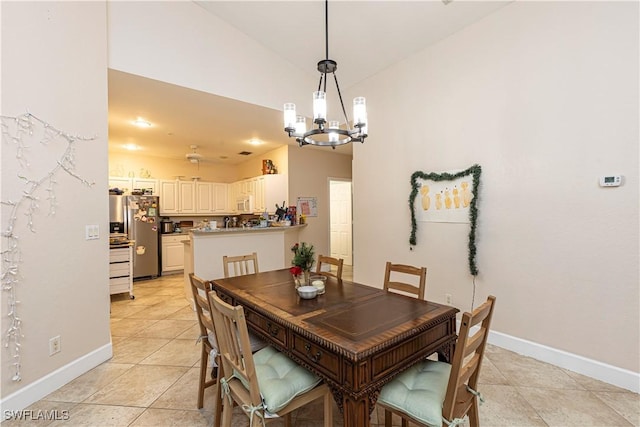 dining area with a chandelier and light tile patterned floors