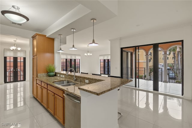 kitchen featuring a notable chandelier, sink, pendant lighting, and dishwasher