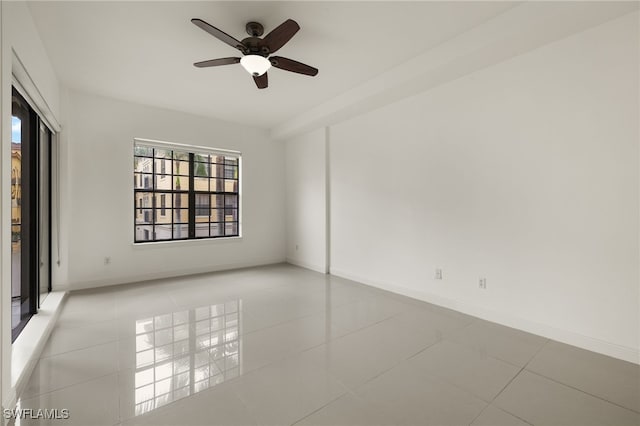 tiled empty room with ceiling fan