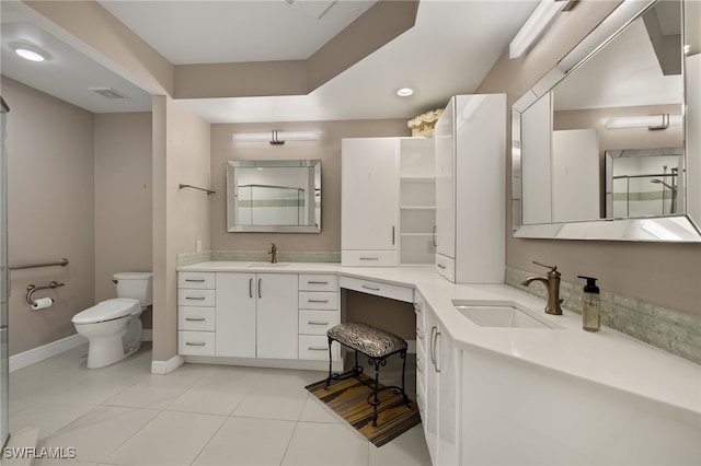 bathroom featuring vanity, toilet, and tile patterned floors