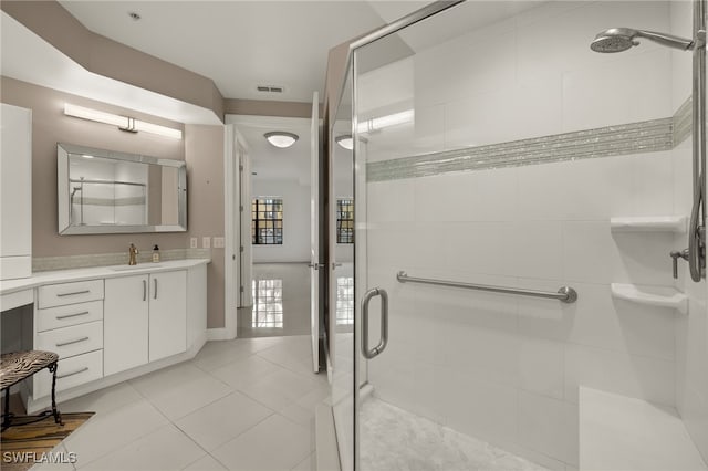 bathroom featuring tile patterned flooring, vanity, and walk in shower