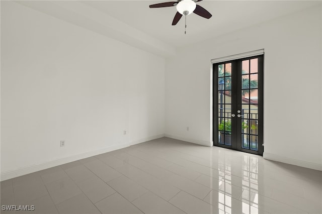 empty room with ceiling fan and french doors