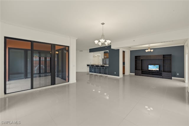 unfurnished living room with tile patterned flooring, crown molding, and a notable chandelier