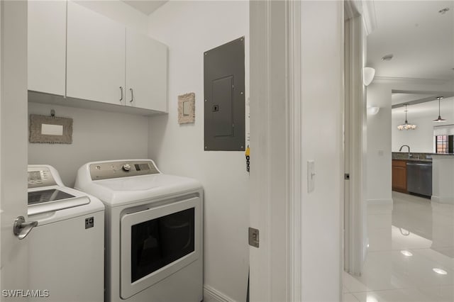 laundry room featuring electric panel and washer and clothes dryer