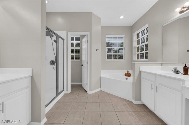 bathroom featuring vanity, plus walk in shower, and tile patterned flooring