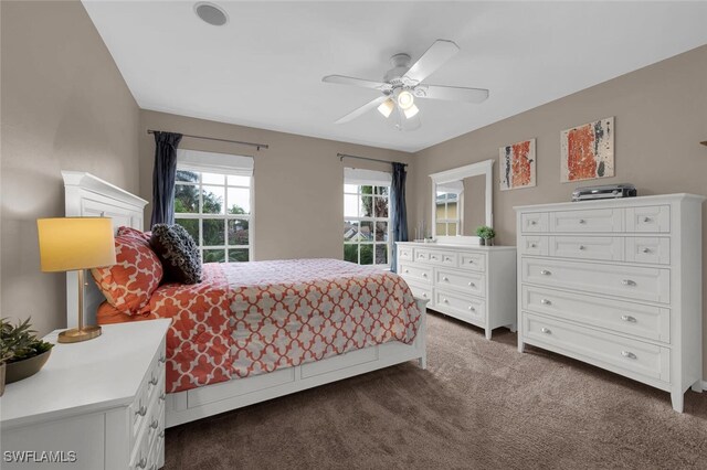 bedroom with dark carpet and ceiling fan