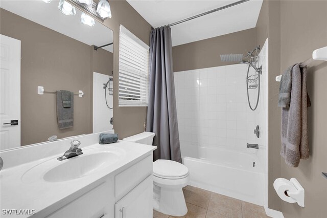 full bathroom featuring vanity, toilet, tile patterned flooring, and shower / bath combo