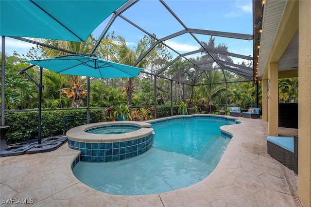 view of swimming pool featuring an in ground hot tub, a lanai, and a patio