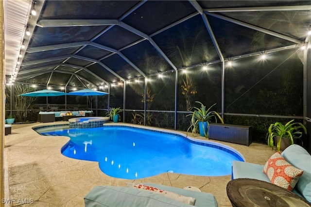 view of swimming pool with an in ground hot tub, a patio, an outdoor hangout area, and glass enclosure