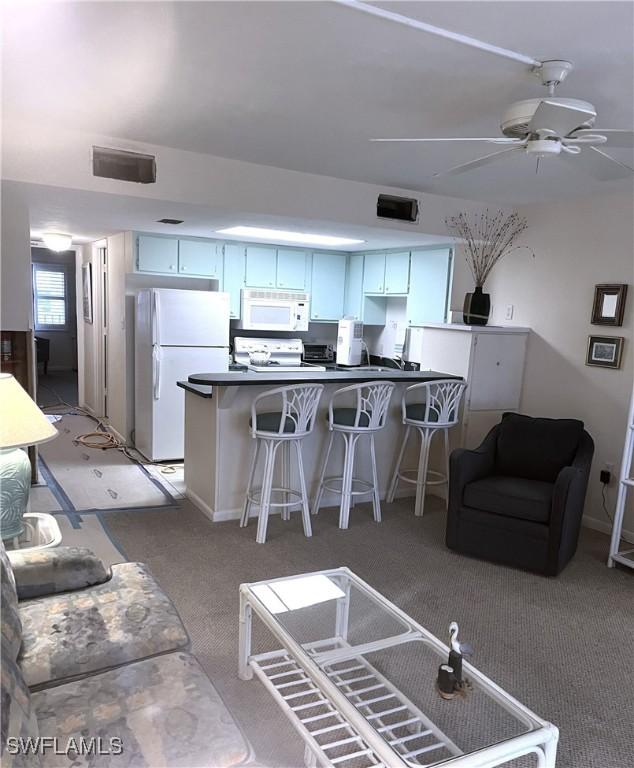 living room featuring ceiling fan and carpet flooring