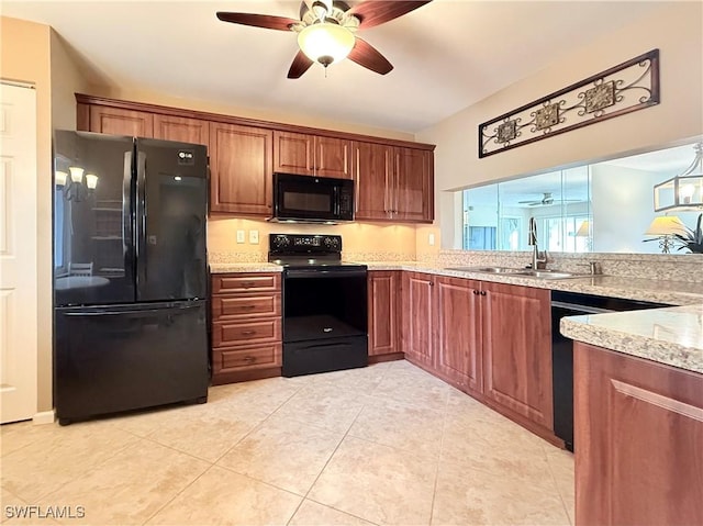 kitchen with sink, ceiling fan, light stone countertops, black appliances, and light tile patterned flooring