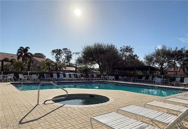 view of pool featuring a patio area and a community hot tub