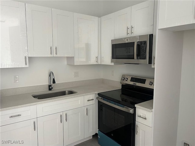 kitchen featuring sink, white cabinets, and stainless steel appliances