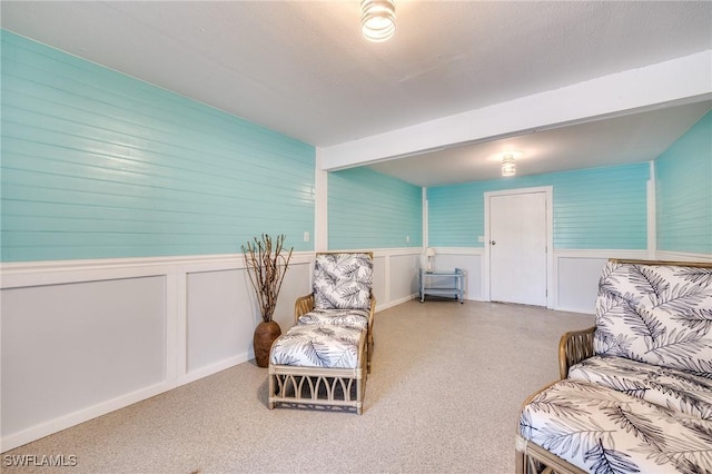 3025 Turtle Gait Ln, Sanibel, FL 33957 - sitting room featuring a wainscoted wall and carpet floors