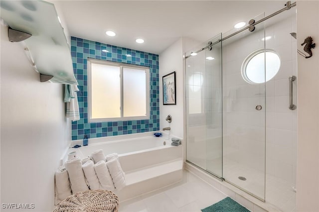 3025 Turtle Gait Ln, Sanibel, FL 33957 - bathroom featuring a stall shower, a healthy amount of sunlight, a garden tub, and tile patterned floors