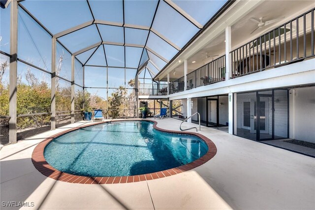 3025 Turtle Gait Ln, Sanibel, FL 33957 - outdoor pool featuring french doors, glass enclosure, and a patio