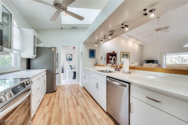 3025 Turtle Gait Ln, Sanibel, FL 33957 - kitchen with stainless steel appliances, ceiling fan, a sink, and rail lighting